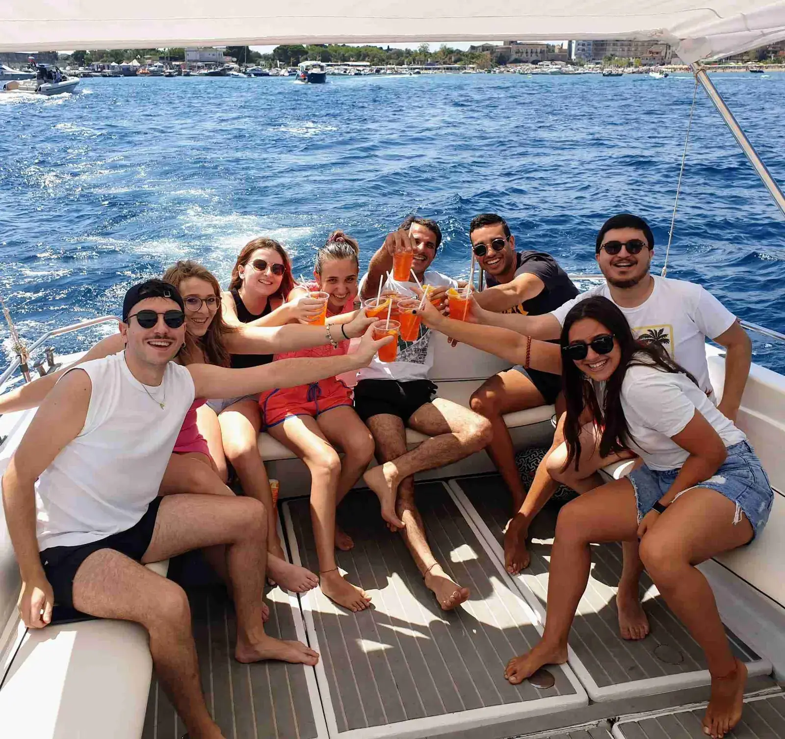 A group of friends toasting with prosecco on board